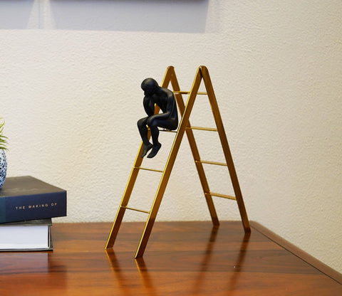 Black Human on a Staircase Figurine