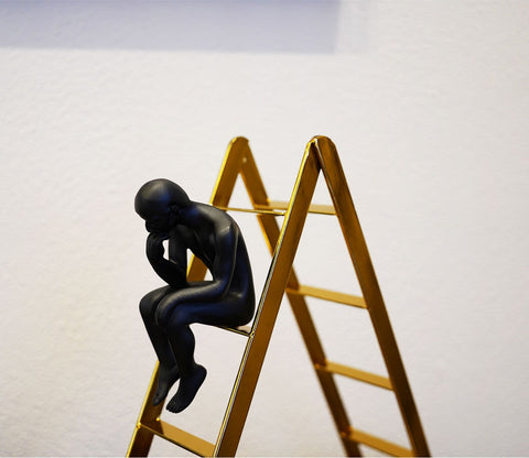 Black Human on a Staircase Figurine