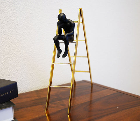 Black Human on a Staircase Figurine